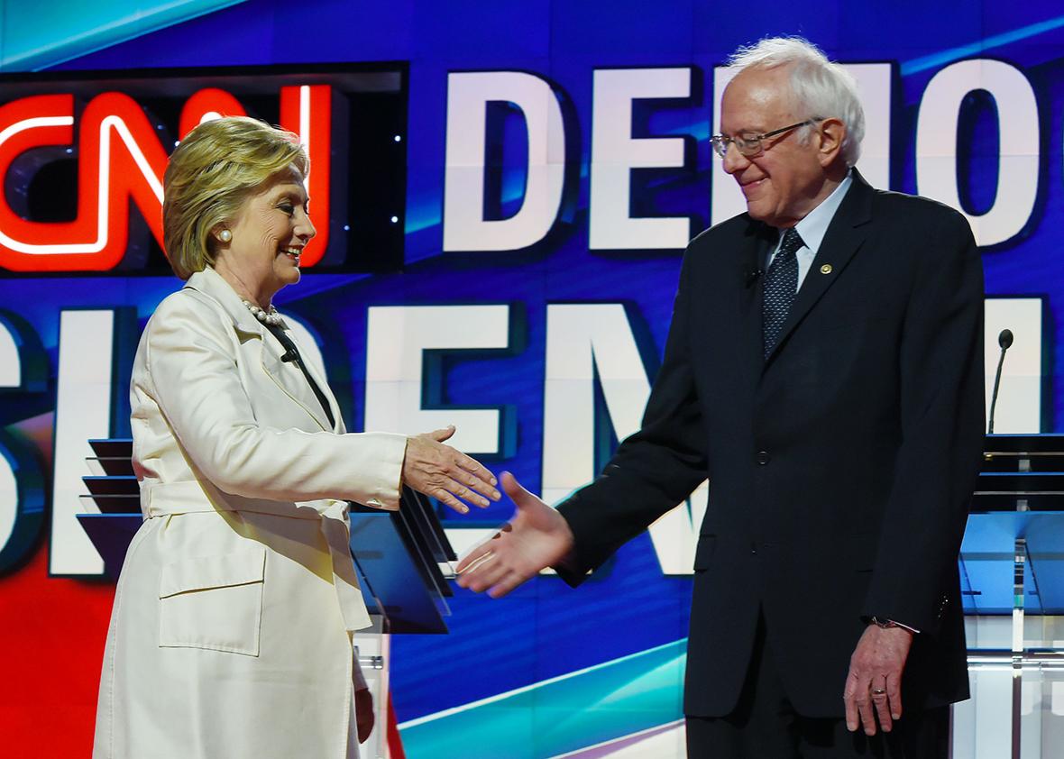 US Democratic presidential candidates Hillary Clinton and Bernie Sanders shake hands before the CNN Democratic Presidential Debate at the Brooklyn Navy Yard on April 14, 2016, in New York. 