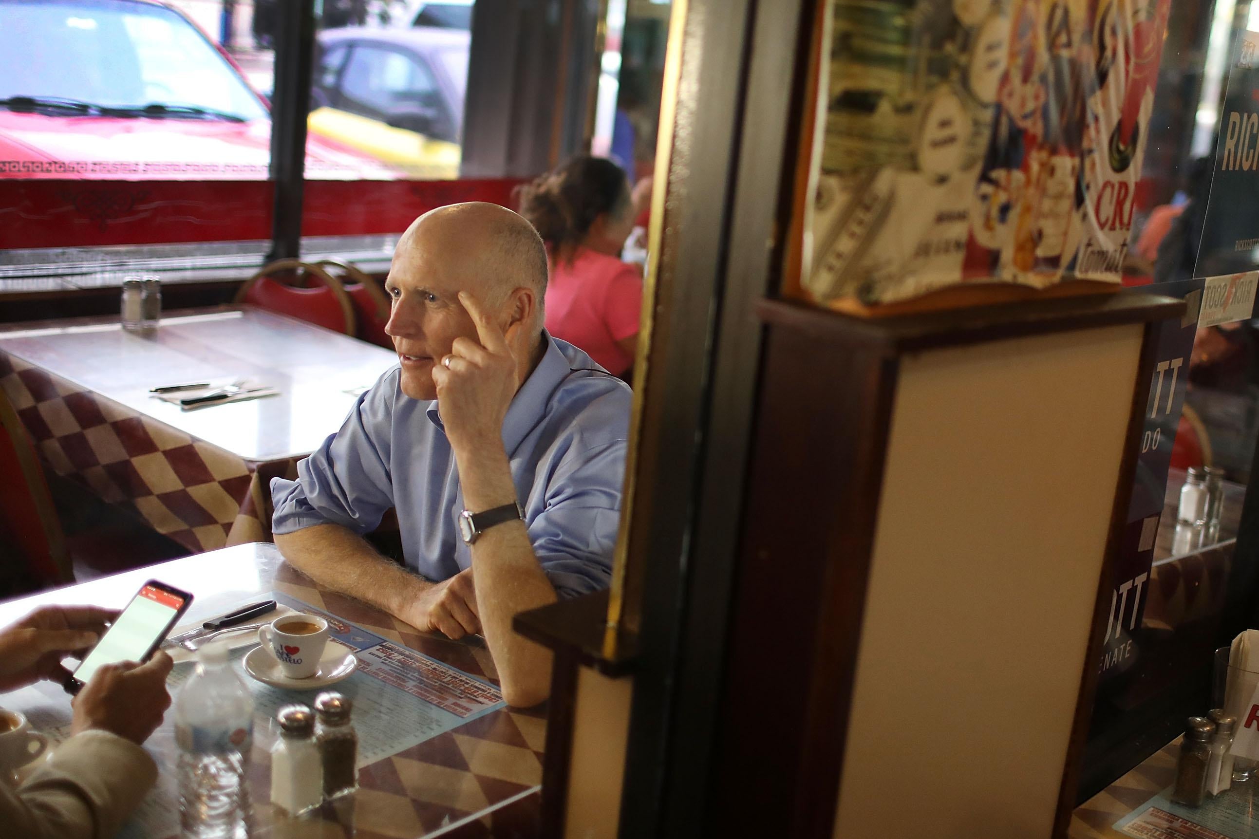 Florida Governor Rick Scott makes a campaign stop at a Cuban restaurant in June.