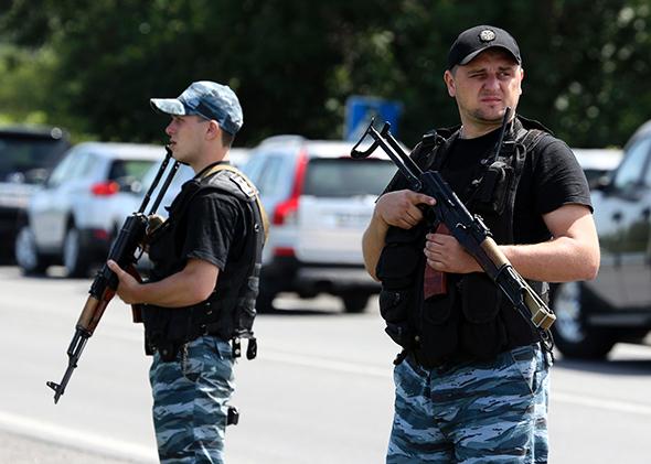 Armed pro-Russian separatists stand guard in the suburbs of Shakhtarsk in the Donetsk region of Ukraine on July 28, 2014.