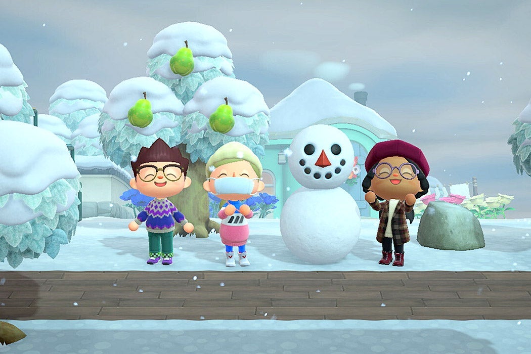 Characters next to a snowman in Animal Crossing: New Horizons.