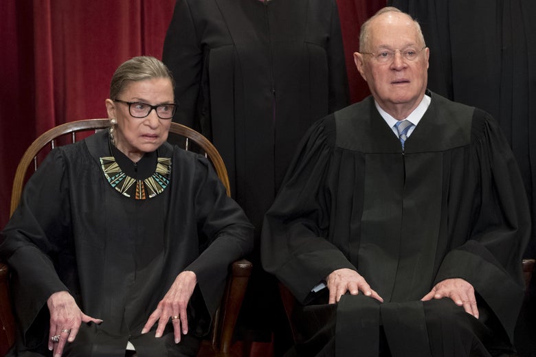Supreme Court Justices Ruth Bader Ginsburg and Anthony Kennedy sit for an official photo with other members of the Supreme Court.