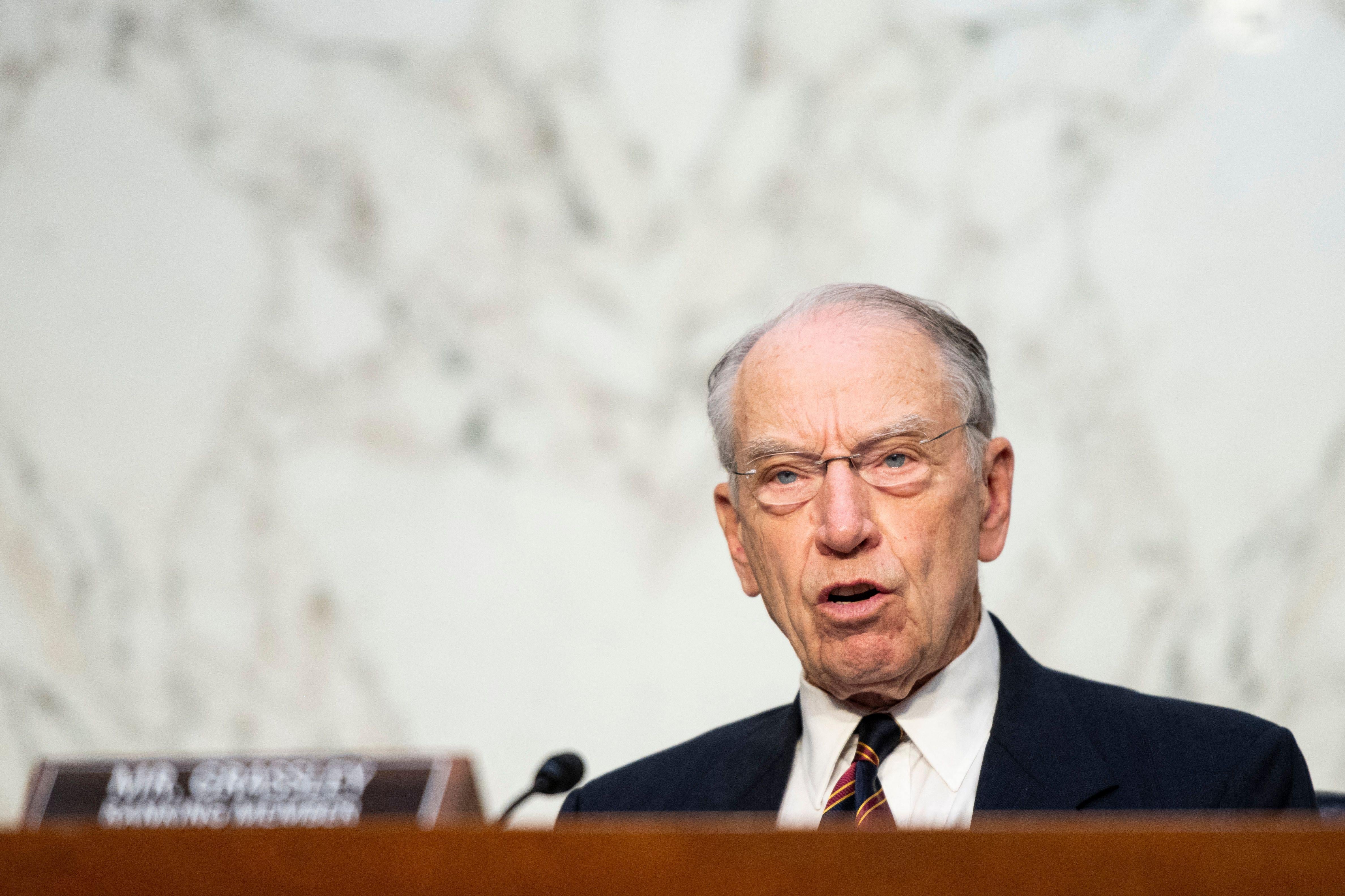 Grassley speaks into a microphone at a hearing.