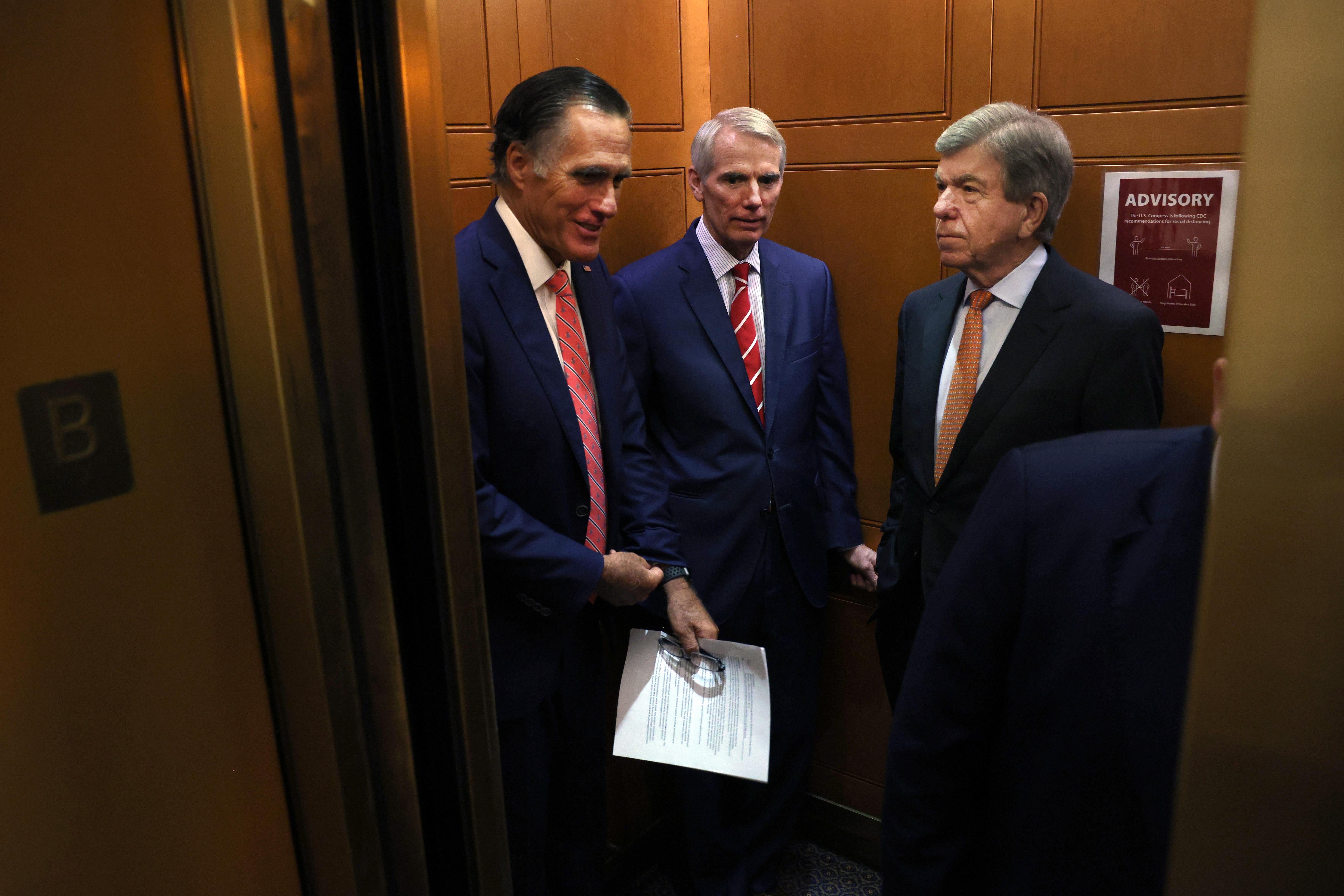 WASHINGTON, DC - JULY 13: (L-R) Sen. Mitt Romney (R-UT), Sen. Rob Portman (R-OH) and Sen. Roy Blunt (R-MO) ride an elevator as they leave a bipartisan meeting on infrastructure at the U.S. Capitol on July 13, 2021 in Washington, DC. The Senate returned from a two-week recess with hopes of passing a more than $1 trillion bipartisan infrastructure plan. (Photo by Kevin Dietsch/Getty Images)