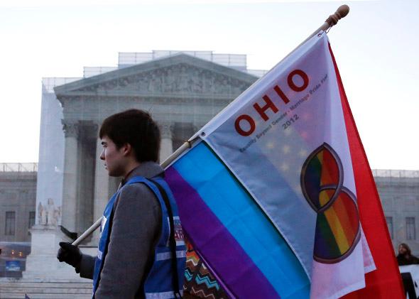 A protester from Ohio carries a flag outside of the U.S. Supreme Court.