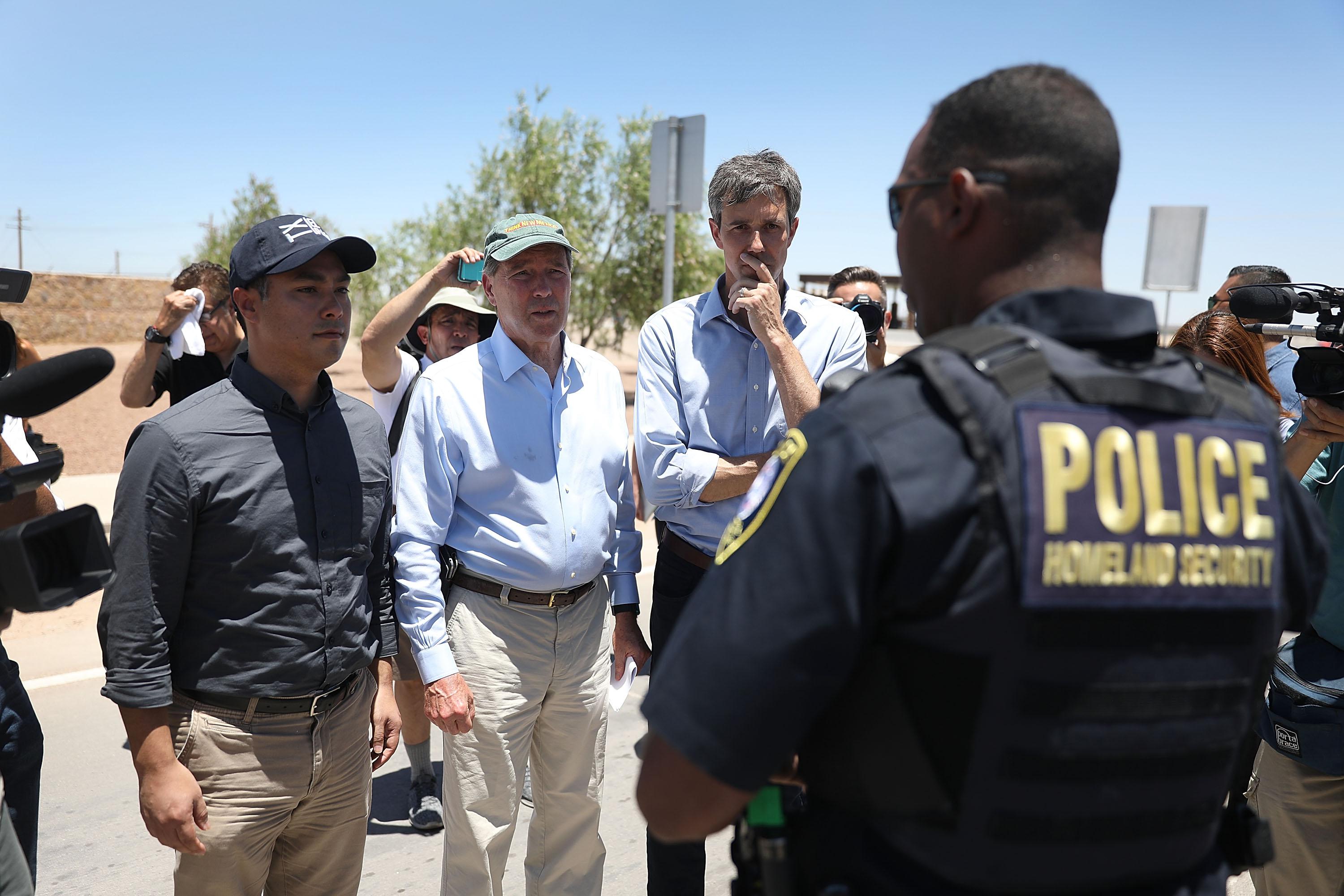 Rep. Joaquin Castro (D-TX), U.S. Senator Tom Udall (D-NM) and Rep. Beto O'Rourke (D-TX)(L-R) are briefed by a Department of Homeland Security police officer before touring a tent encampment near the Tornillo-Guadalupe Port of Entry on June 23, 2018 in Tornillo, Texas. 