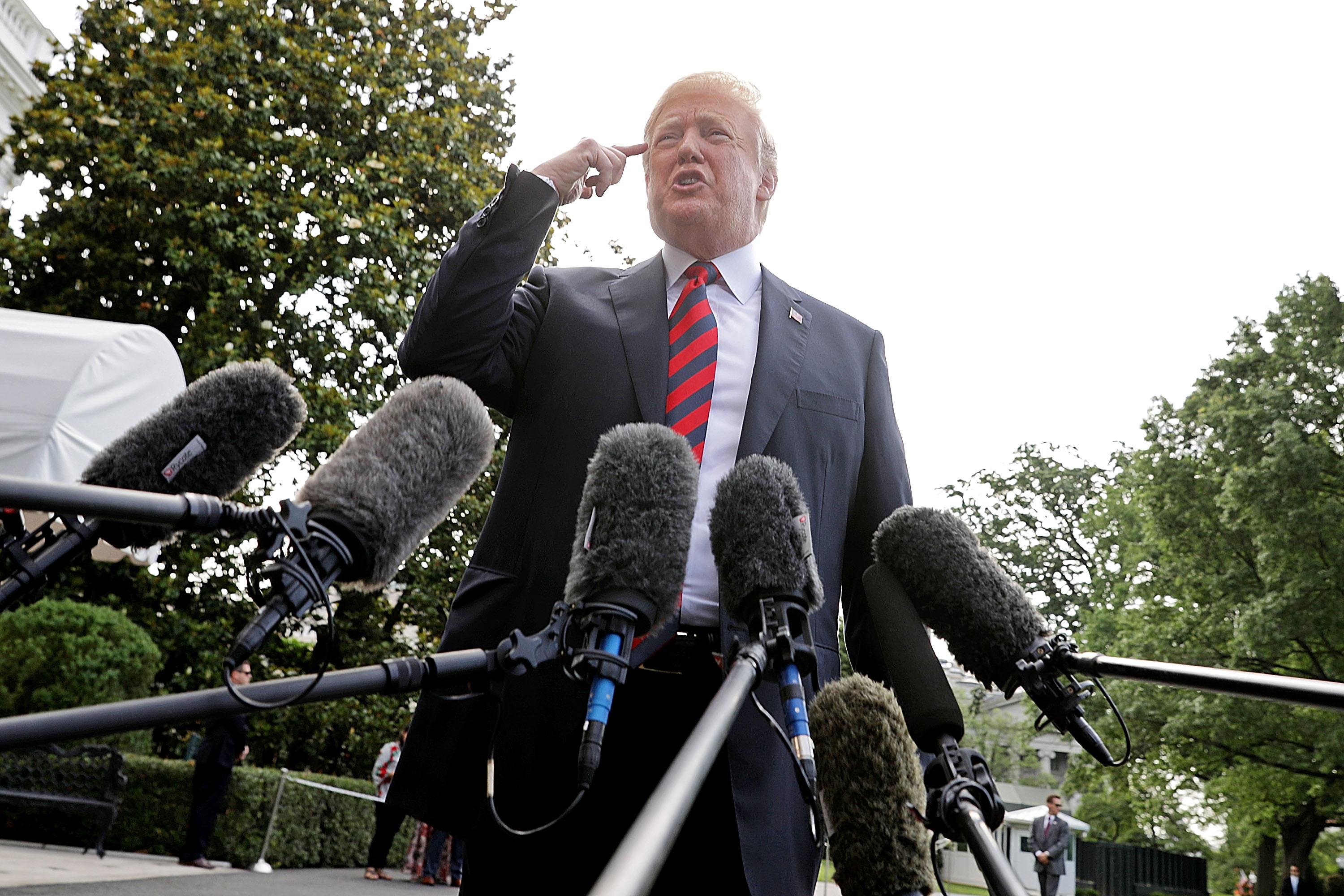 President Donald Trump talks to reporters as he departs the White House June 8, 2018 in Washington, D.C. 