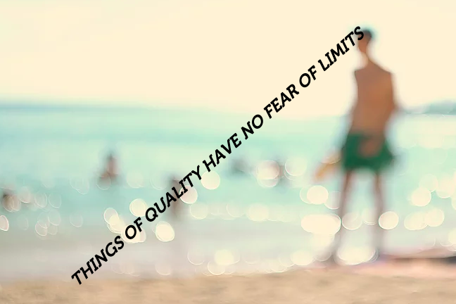 A blurry image of someone walking on the beach with the words "Things of quality have no fear of limits" written in all caps, diagonally.
