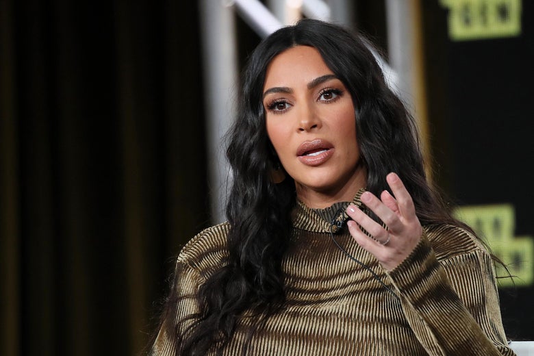 Kim Kardashian West speaks onstage, gesturing with one hand