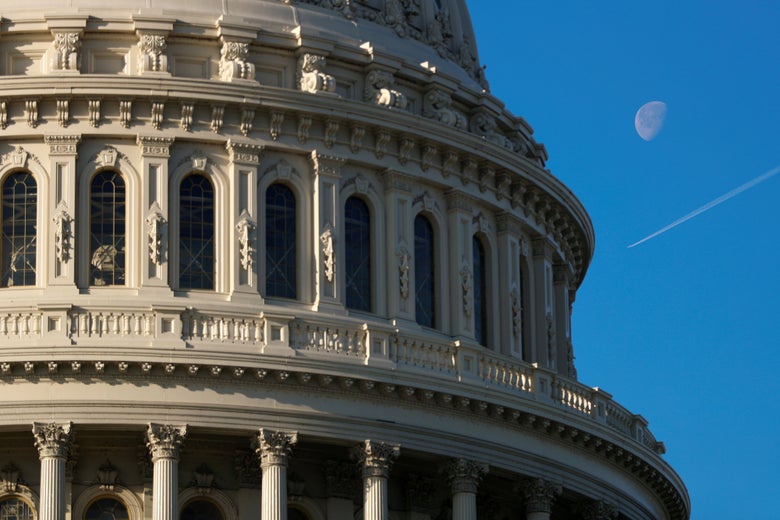 A plane flies across the sky beside the U.S. Capitol dome in Washington, D.C. on January 15, 2020.