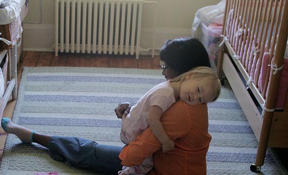 A nanny from gets a hug from the child she looks after in Brooklyn, New York.
