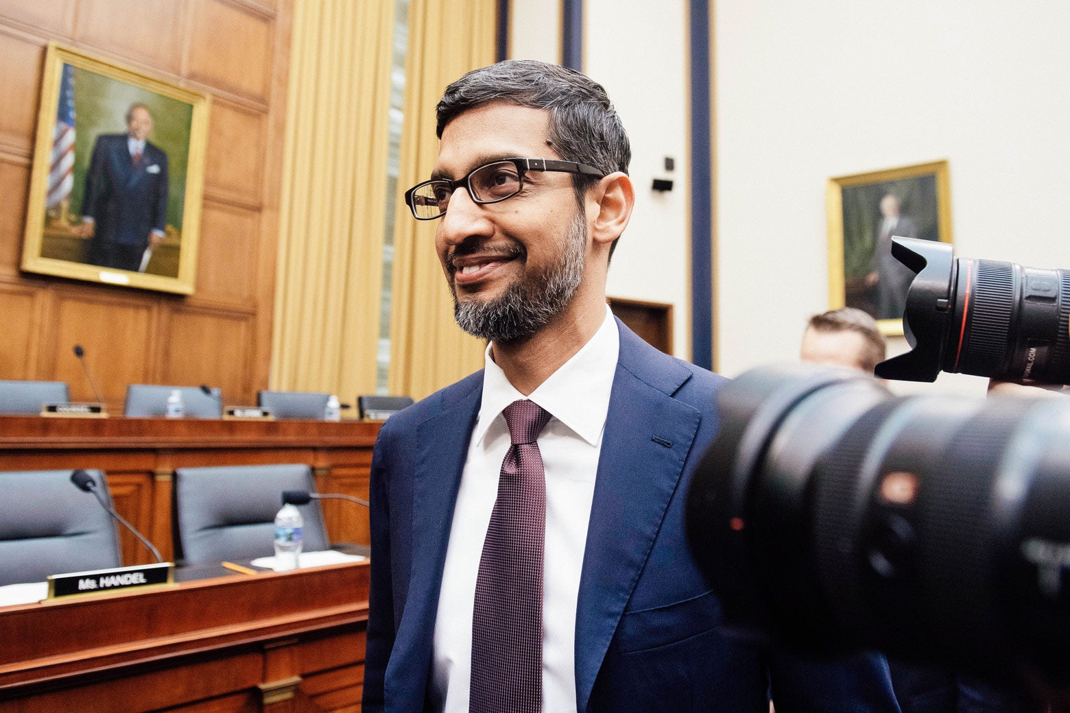 Google CEO Sundar Pichai smiles in profile for the press cameras as he arrives to testify during a House Judiciary Committee hearing in Washington on Tuesday.