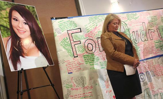 Sheila Pott pauses in front of a portrait of her teenage daughter, Audrie Pott, at a news conference in San Jose, California April 15, 2013.