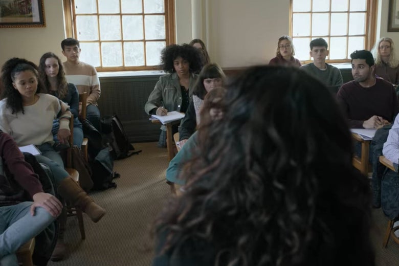 The back of Dr. Kim's head as she looks at a college classroom with about a dozen students in it.