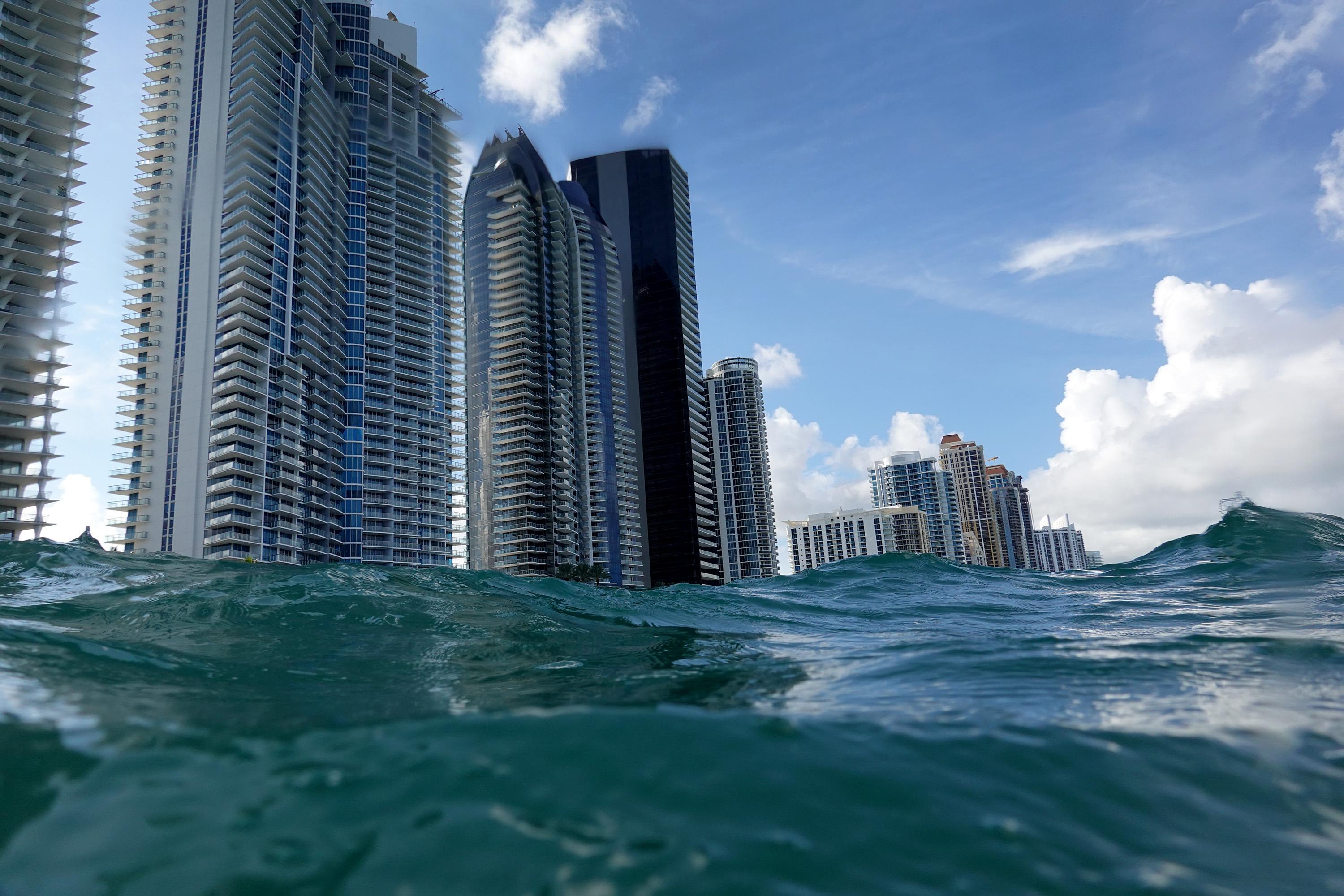 Waves lap ashore near condo buildings in Florida.