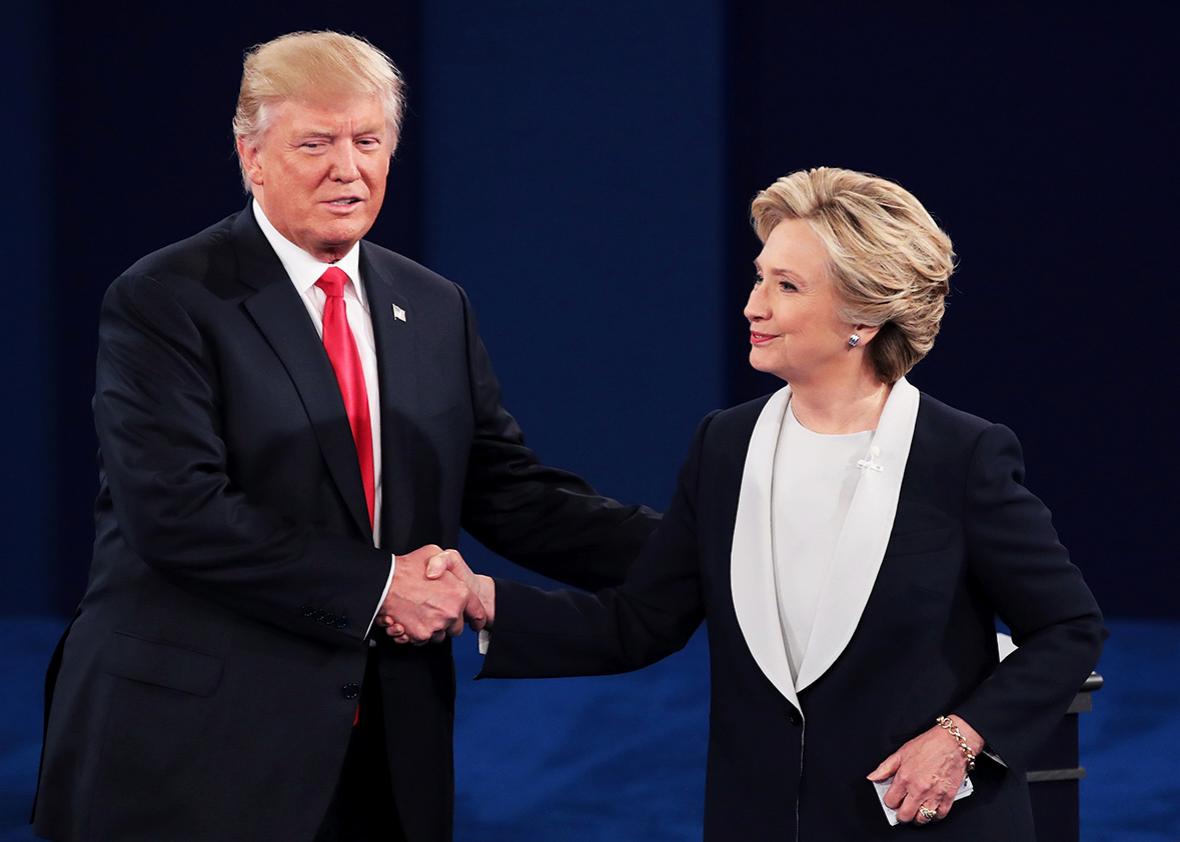 Republican presidential nominee Donald Trump shakes hands with Democratic presidential nominee former Secretary of State Hillary Clinton during the town hall debate at Washington University on October 9, 2016 in St Louis, Missouri.  