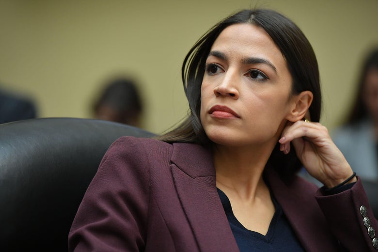 Rep. Alexandria Ocasio-Cortez (D-NY) listens as Michael Cohen testifies before the House Oversight and Reform Committee in the Rayburn House Office Building on Capitol Hill in Washington, D.C. on February 27, 2019.