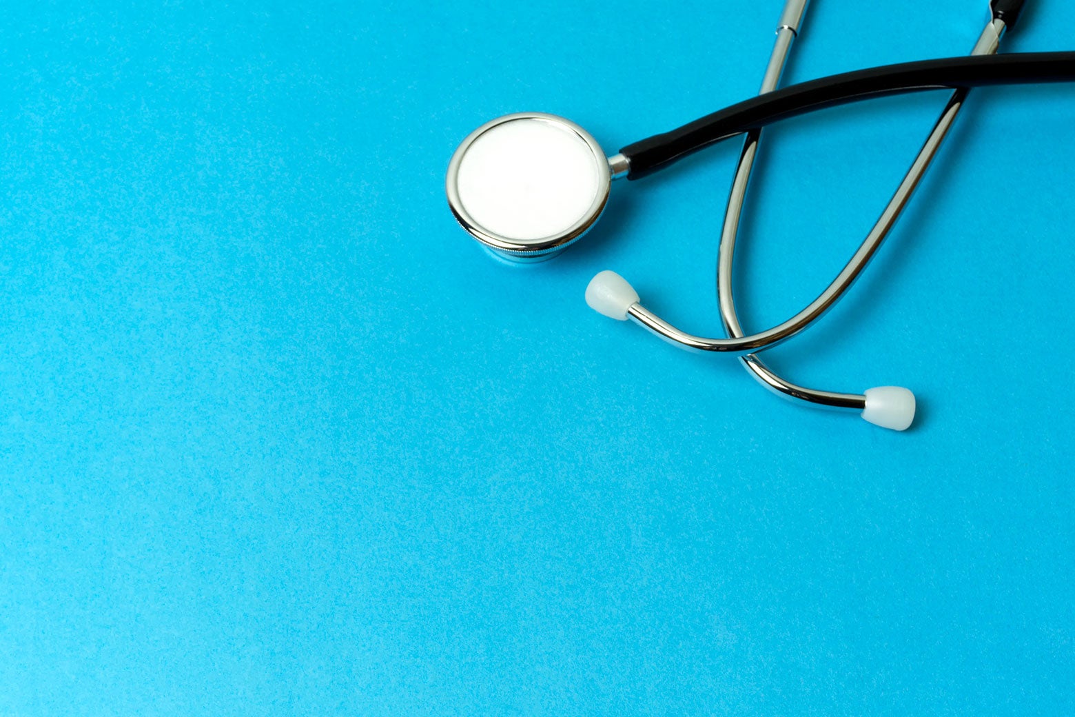 A stethoscope on a solid blue background.
