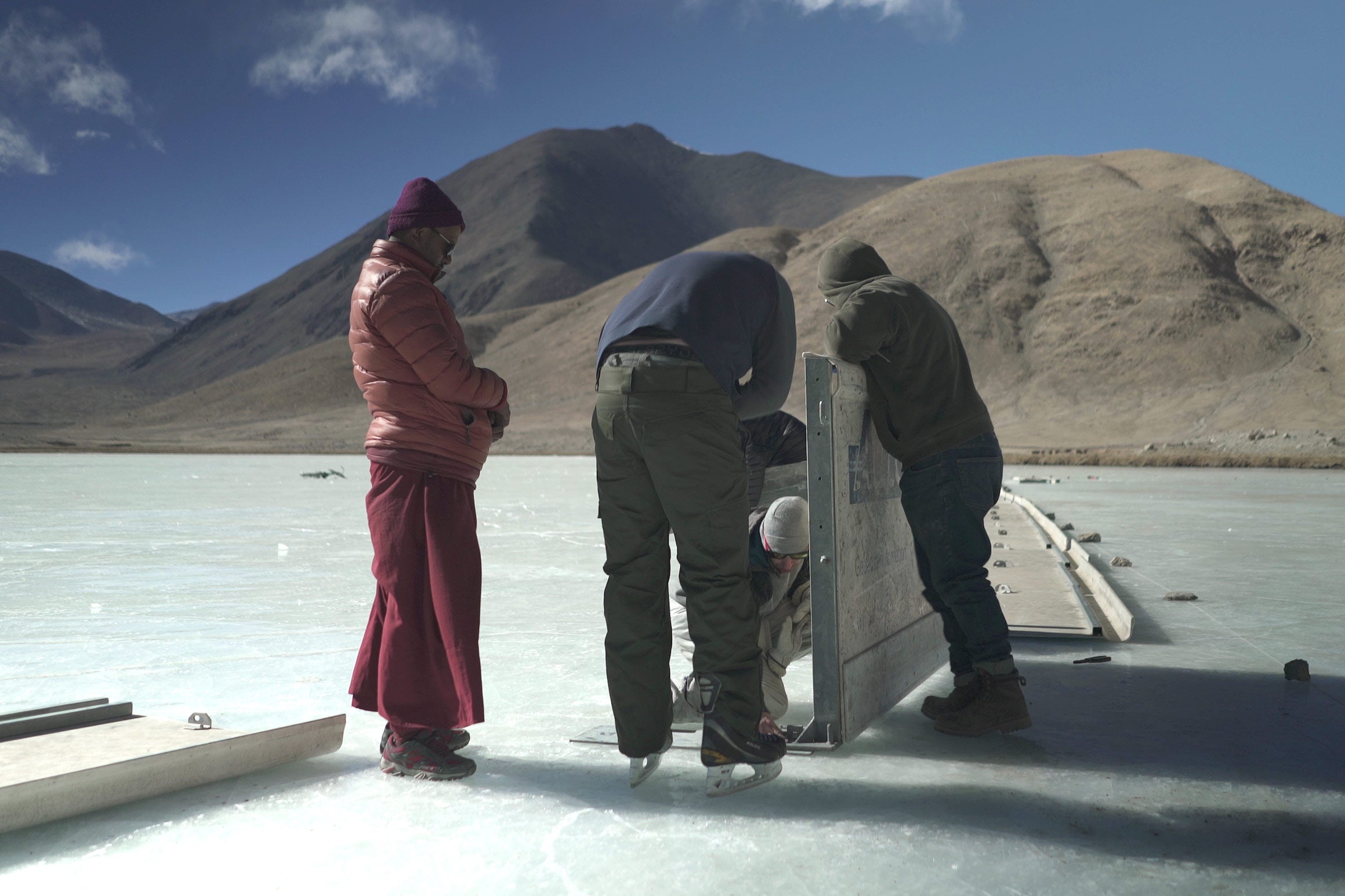 Volunteers from the the Hockey Foundation and local Ladakhis set up boards for the hockey rink.