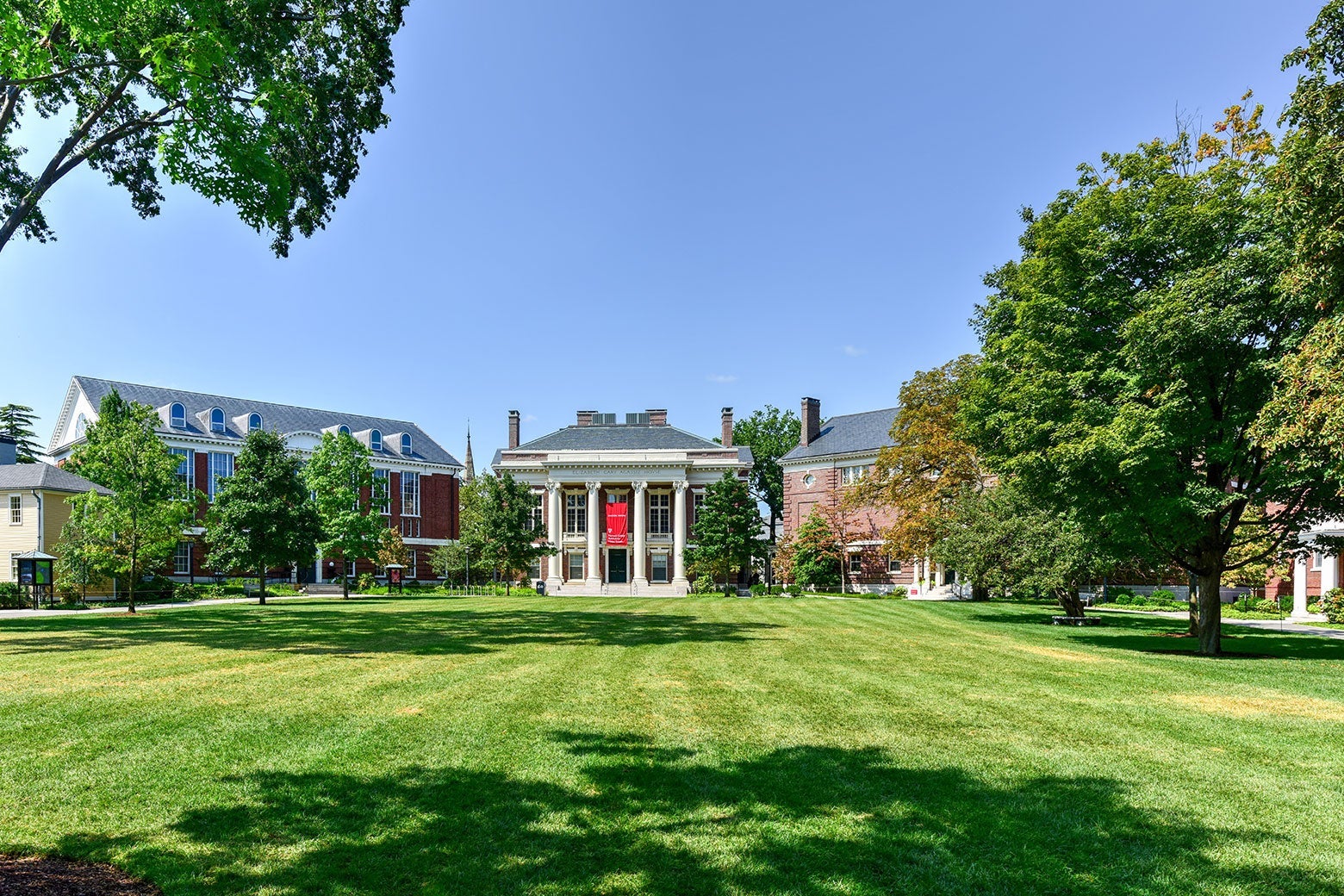 Colonial-style buildings opening onto an immaculate lawn.