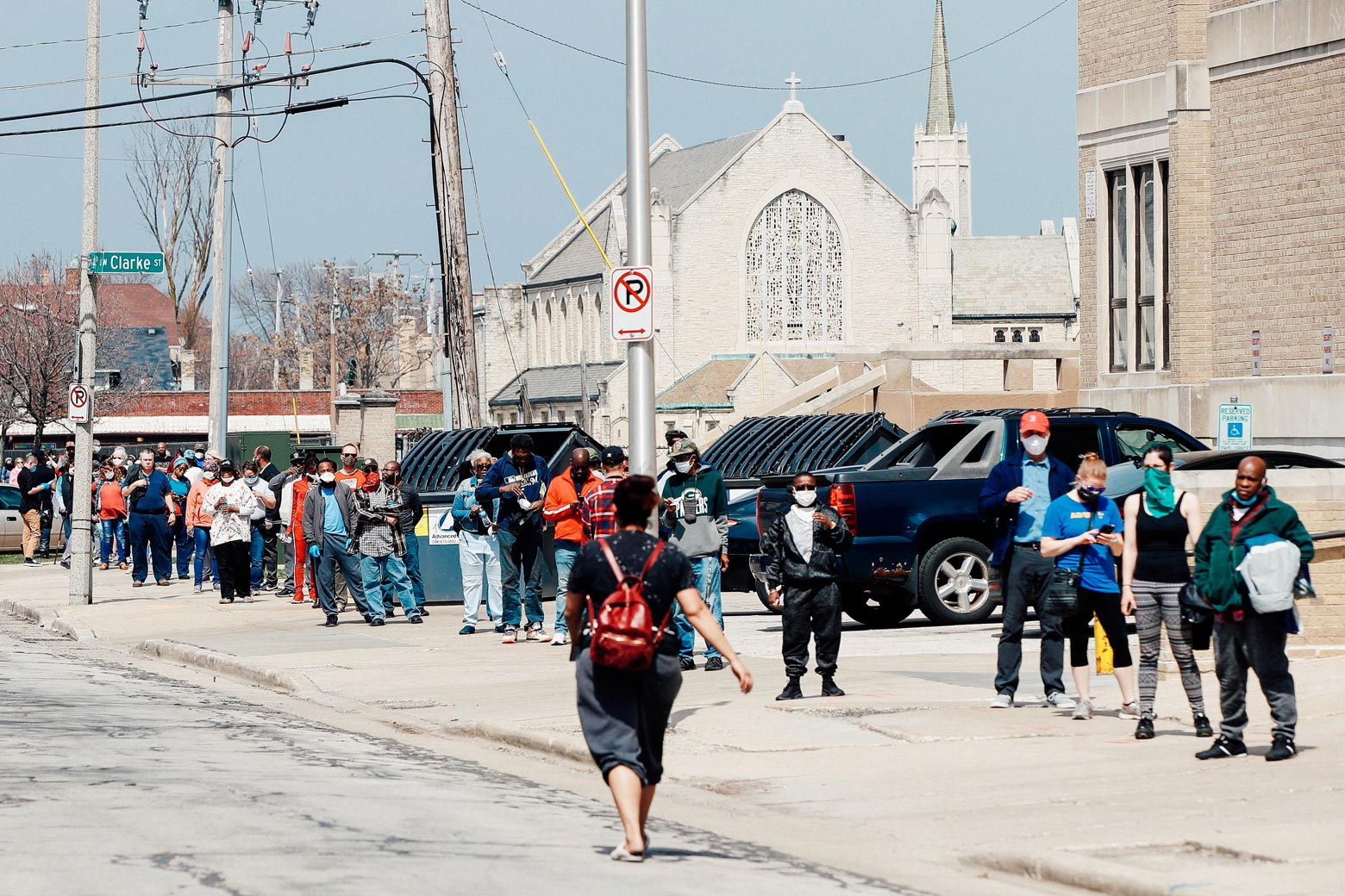 Long line of people wrapped around a street corner in Milwaukee.