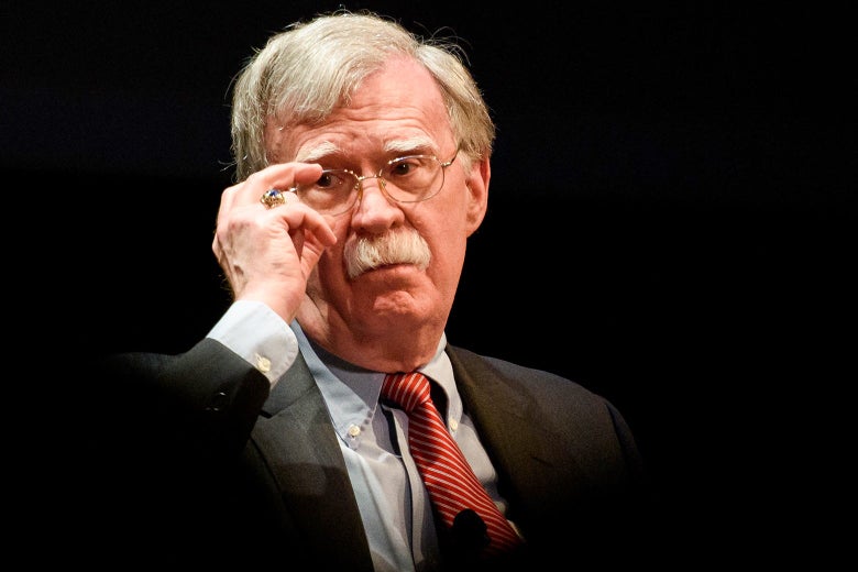 John Bolton adjusts his glasses.