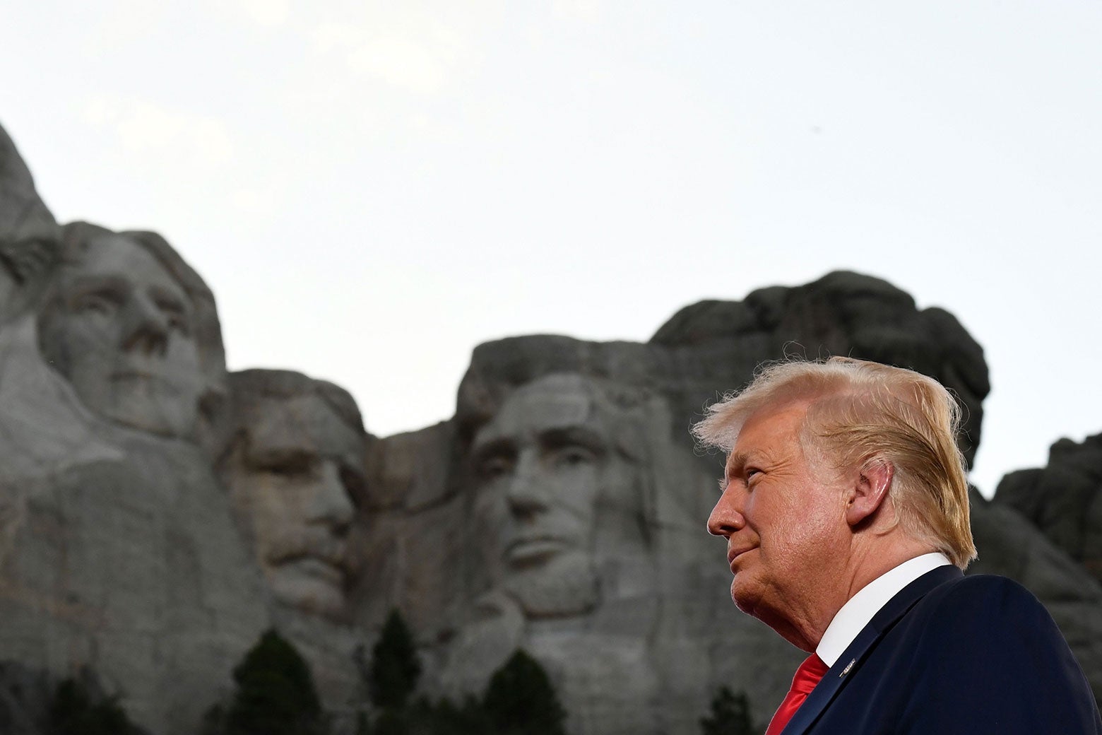President Donald Trump standing in front of Mount Rushmore.