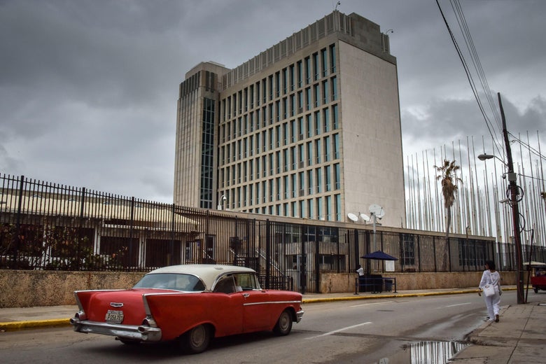 The U.S. embassy in Havana with a classic vintage car out front.