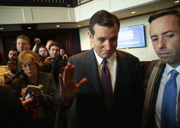 U.S. Senator Ted Cruz (R-TX) waves as he leaves after he addressed the Heritage Action for America's Conservative Policy Summit February 10, 2014 in Washington, DC. 