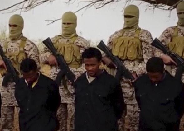 Islamic State militants stand behind what are said to be Ethiopian Christians in Wilayat Fazzan, in this still image from an undated video made available on a social media website on April 19, 2015. 