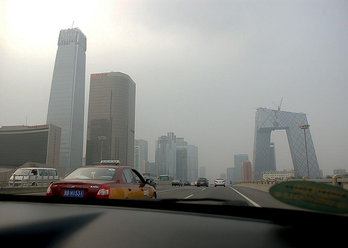 Driving through the smog on the Third Ring Road in Beijing, Chin