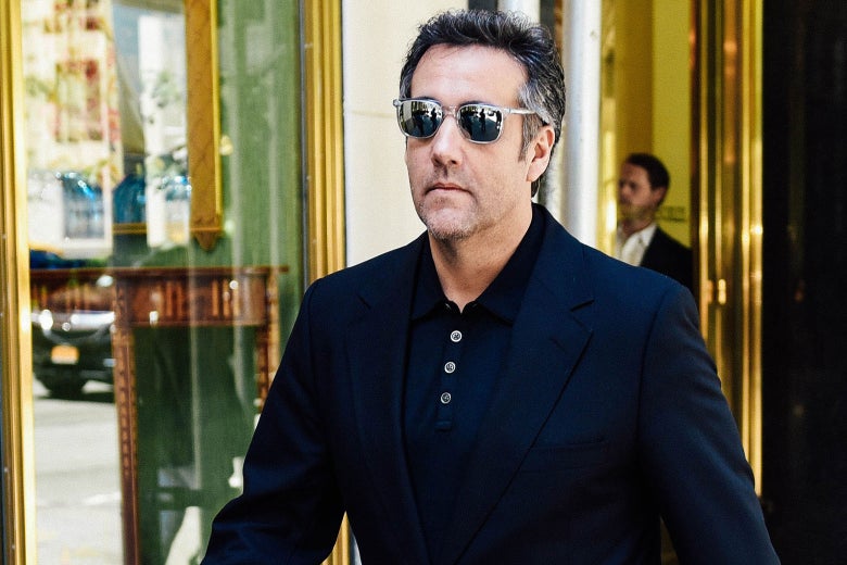Michael Cohen walks down Park Avenue in sunglasses, a blazer, and a polo.