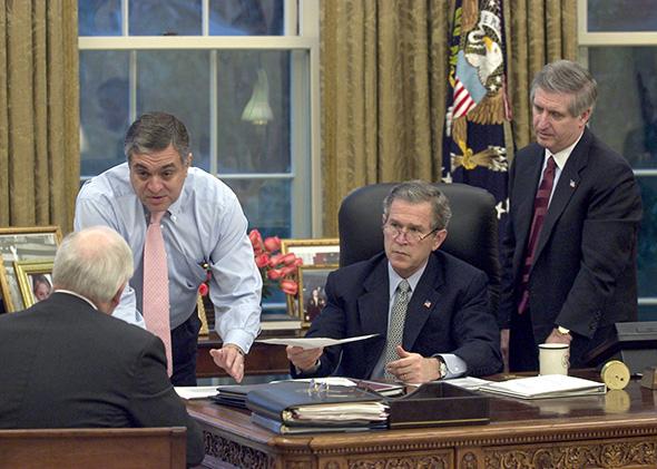 President George W. Bush receives an update on the status of military action in Iraq on March 20, 2003, in the Oval Office. Present are Vice President Dick Cheney, CIA Director George Tenet, and chief of staff Andy Card.
