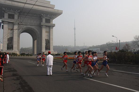 Korean participants in the 2014 Pyongyang Marathon run past the Arch of Triumph, built to commemorate the end of Japanese colonial rule.
