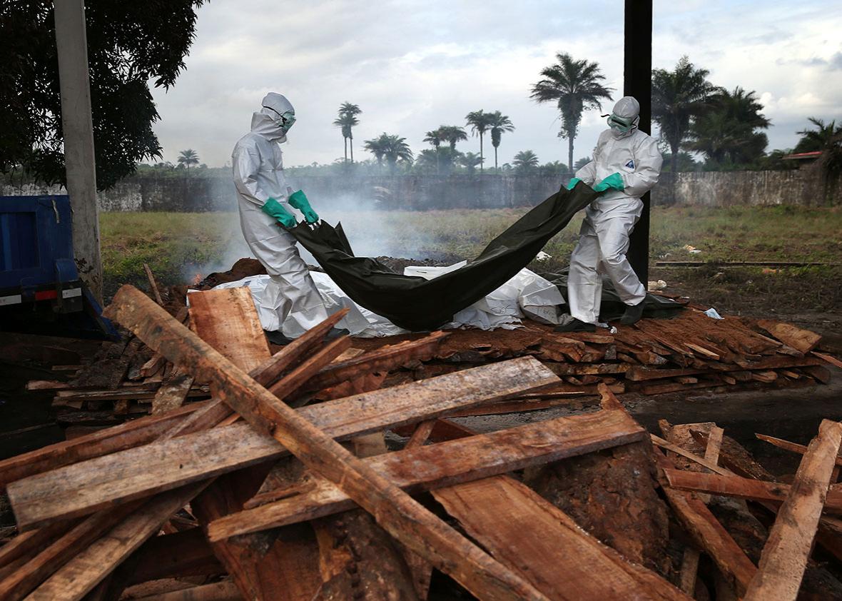 A burial team from the Liberian Ministry of Health unloads the b