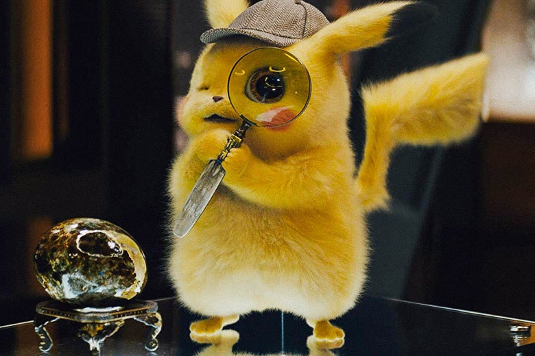 A Pikachu, voiced by Ryan Reynolds, is wearing a detective hat and holding a very large magnifying glass up to its face.