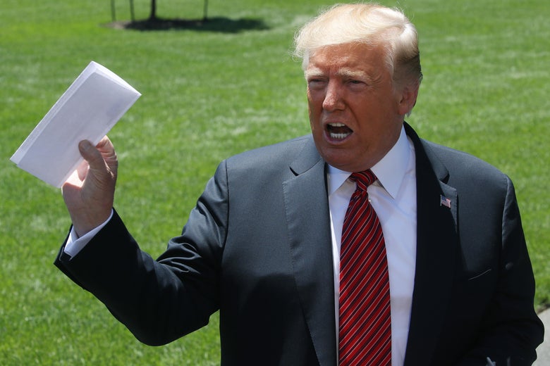 President Donald Trump holds a piece of paper he said was a trade agreement with Mexico, while speaking to the media before departing from the White House on June 11, 2019 in Washington, D.C.