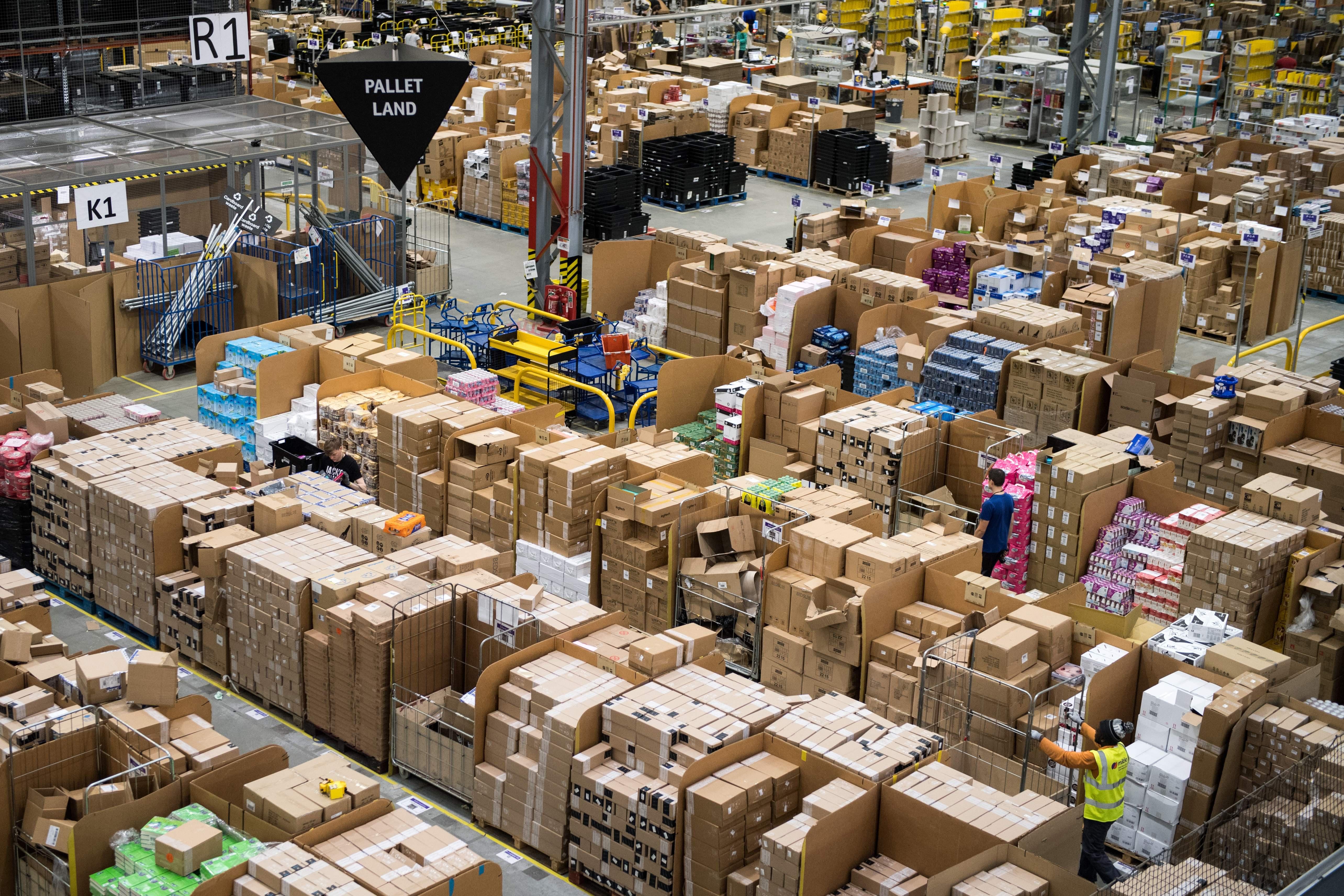 Workers prepare customer orders for dispatch as they work around goods stored inside an Amazon.co.uk fulfillment centre in Peterborough, central England, on November 15, 2017.
Shops could be seeing the effect of consumers postponing purchases until 'Black Friday' on November 24, 2017, a day of sales in the United States that has become increasingly popular in Britain. / AFP PHOTO / CHRIS J RATCLIFFE        (Photo credit should read CHRIS J RATCLIFFE/AFP/Getty Images)