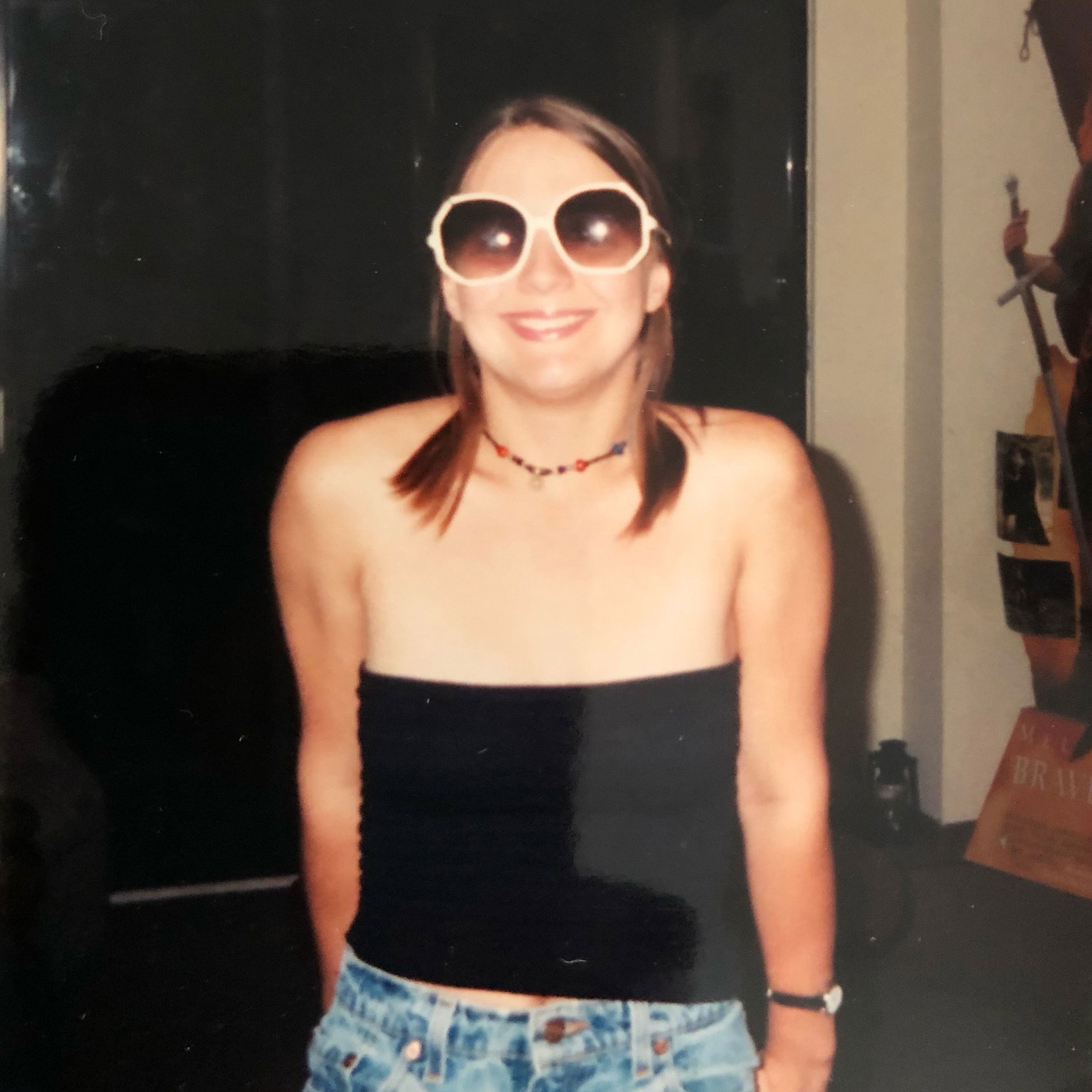 Eve Crawford Peyton at age 22, wearing sunglasses and a necklace.