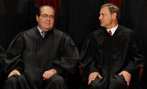 U.S. Supreme Court Associate Justice Antonin Scalia (L) and Chief Justice John Roberts talk.