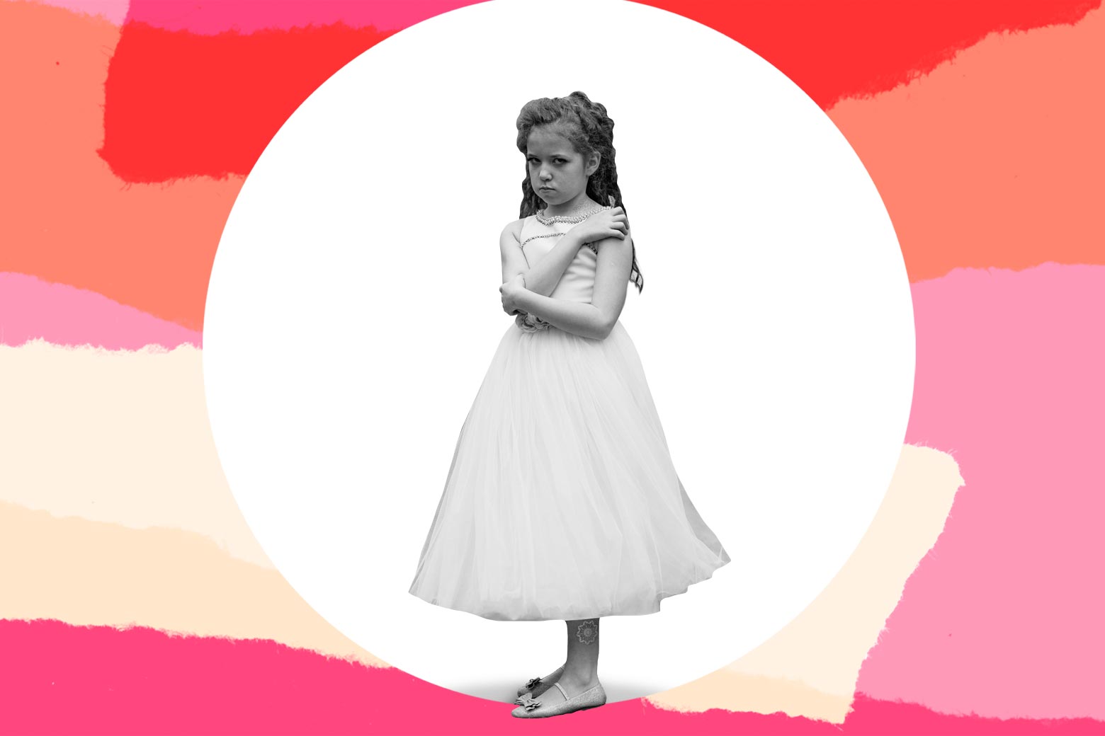 A young girl in a dress looking miserable
