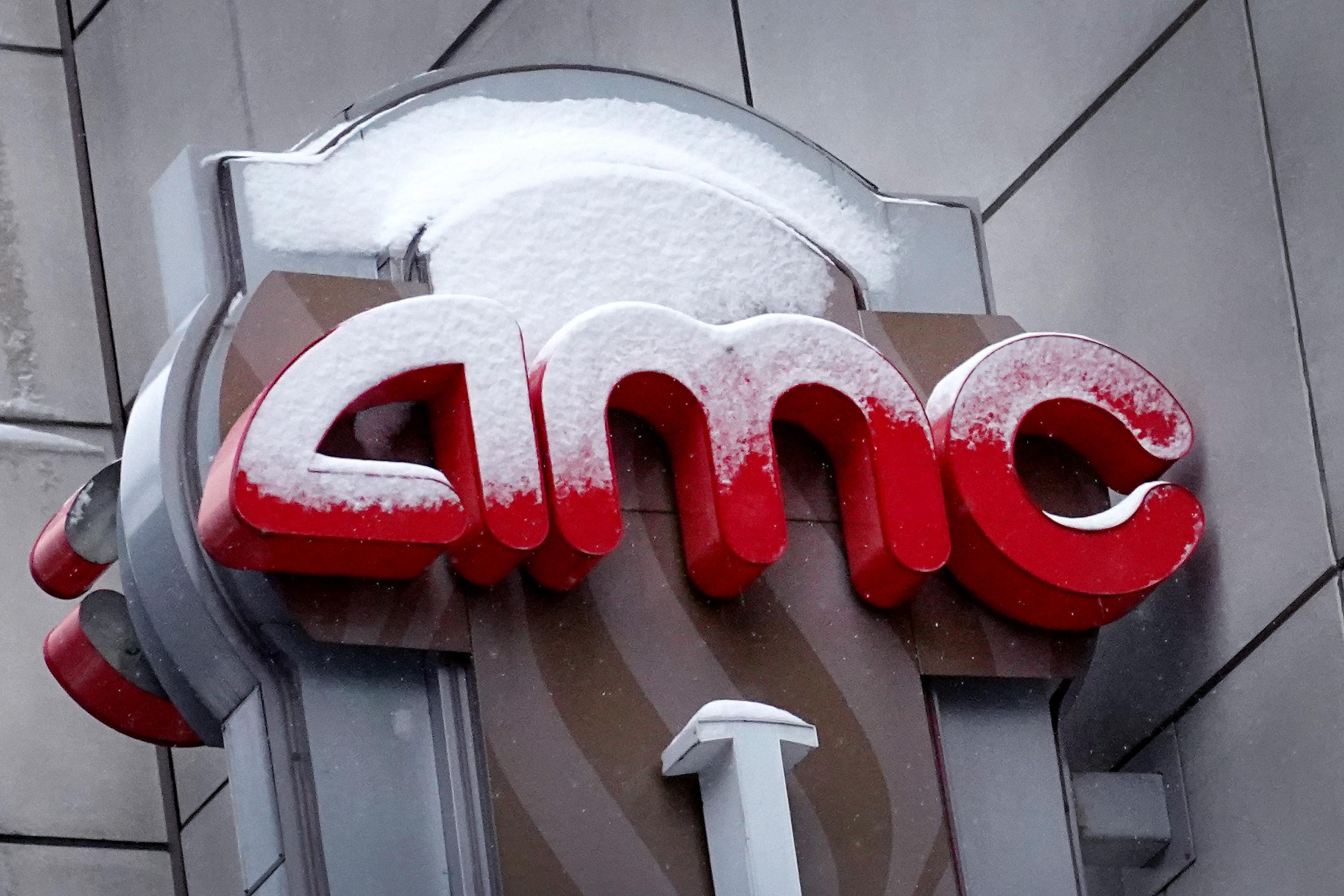 Snow-covered AMC sign outside a movie theater