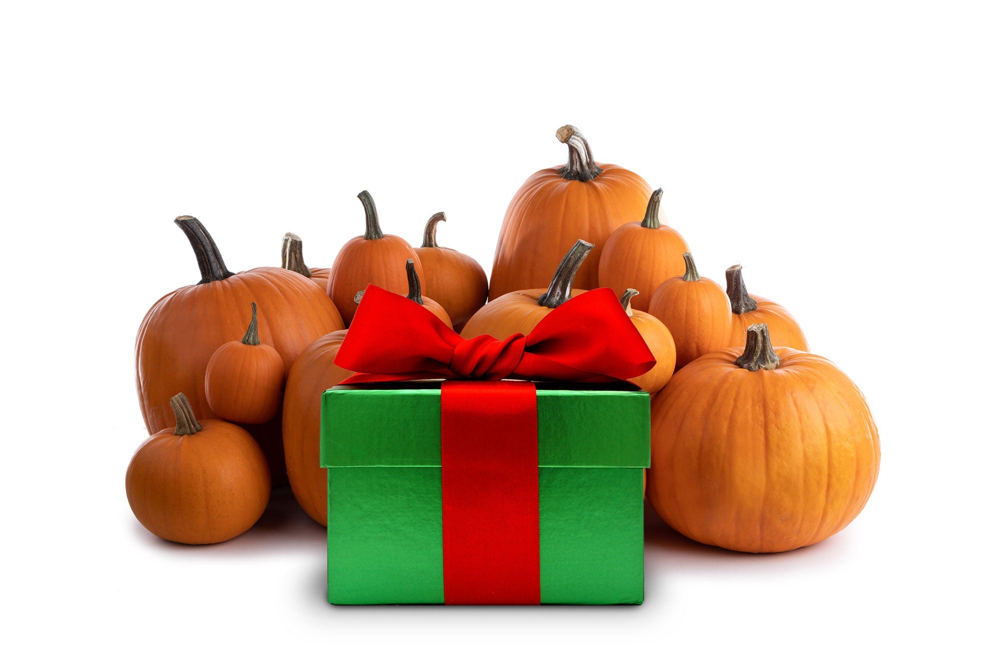 A Christmas gift surrounded by pumpkins.