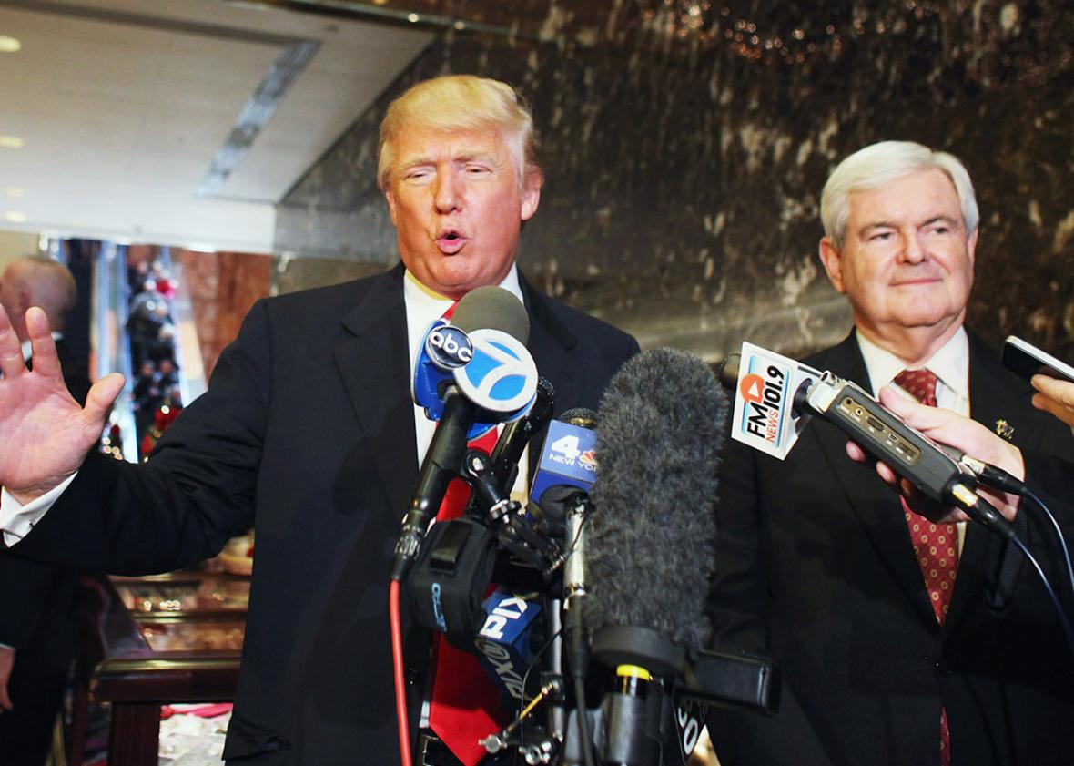 Donald Trump Republican presidential candidate speaks to the media as former Speaker of the House Newt Gingrich listens at Trump Tower following a meeting between the two on December 5, 2011 in New York City. 