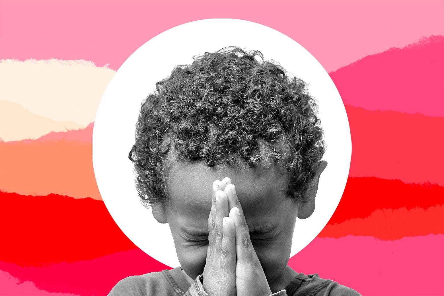 A child holds his hands together in prayer.