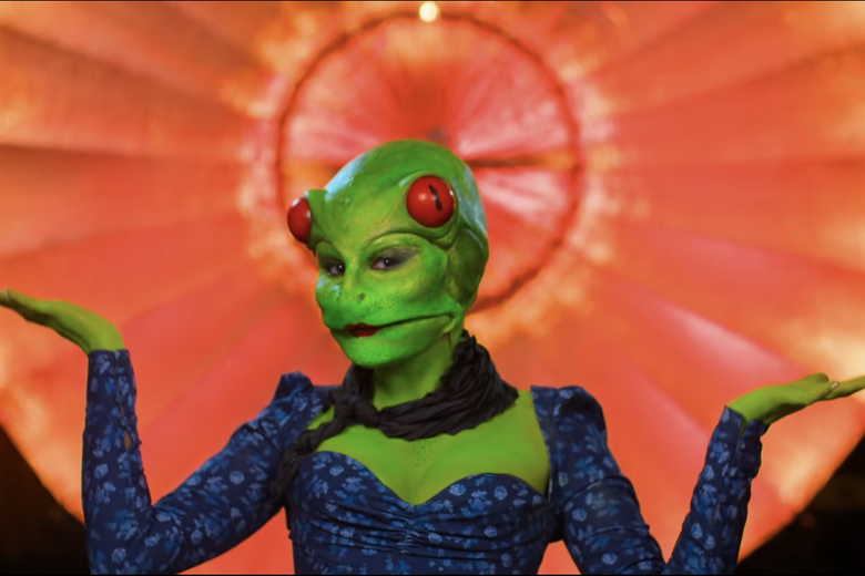 Woman dressed as a frog in a blue dress.