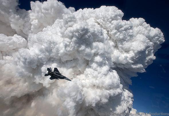 A towering pyrocumulus cloud provides a stunning backdrop for an Oregon Air National Guard F-15C fighter jet.