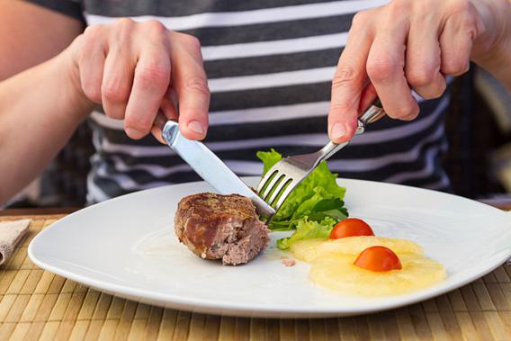 Fork, knife and steak.