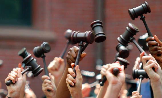 Graduates from the law school hold up gavels in celebration during their commencement at Harvard University in Cambridge, Mass., May 27, 2010.