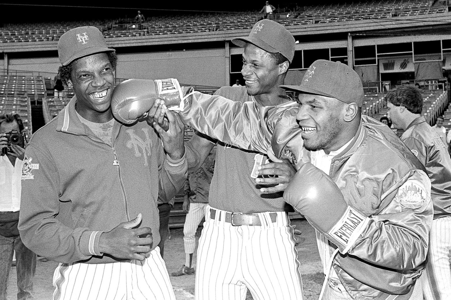 Mike Tyson shows Dwight Gooden how he does it by landing a long right to the amusement of Darryl Strawberry (center) at Shea Stadium prior to the game against the Expos on Sep. 9, 1986.