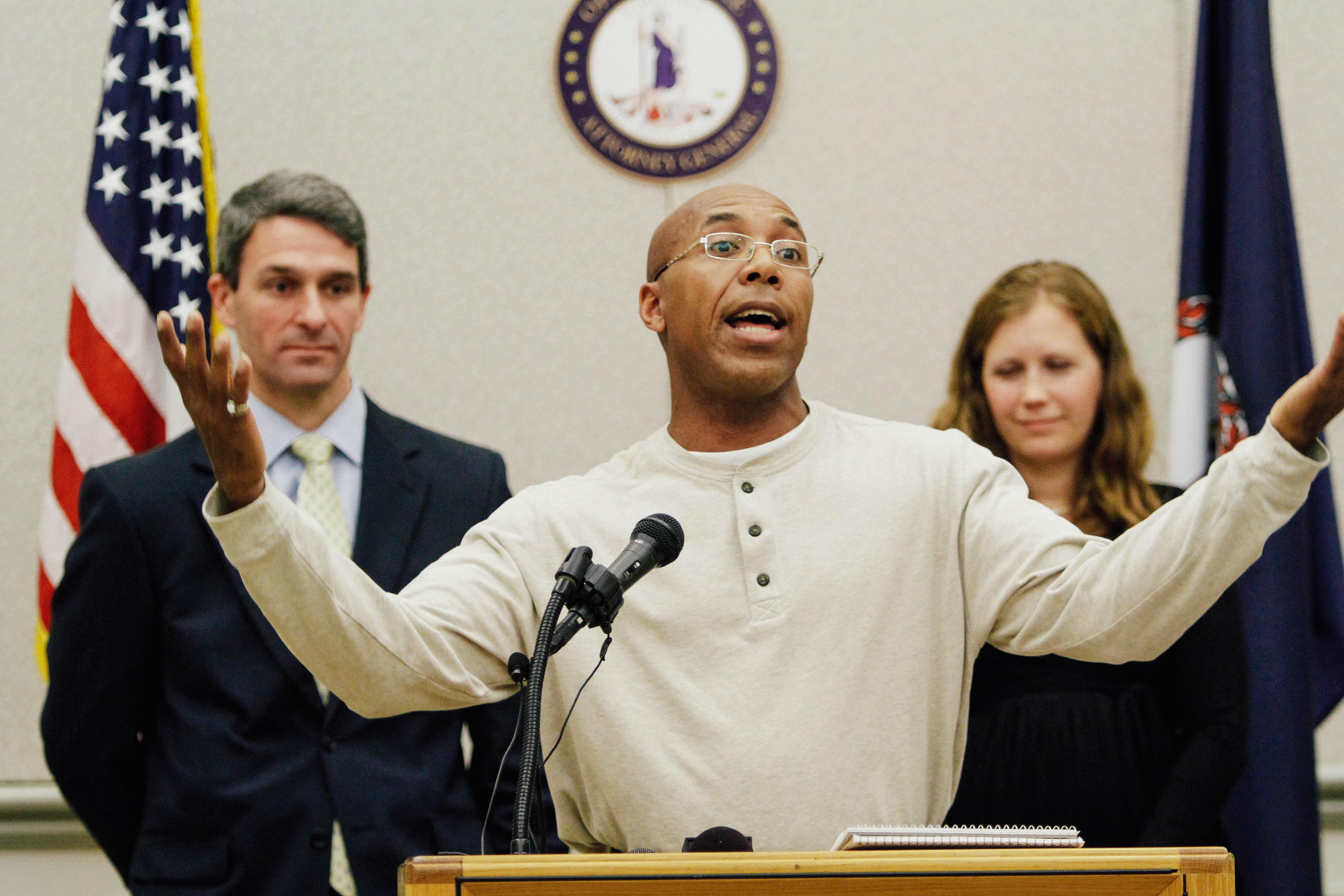 Virginia Attorney General Ken Cuccinelli, Thomas Hanesworth, who spent 27 years behind bars, and Shawn Armbrust, of the Mid Atlantic Innocence Project, right, in Richmond, Va., Tuesday, Dec. 6, 2011.